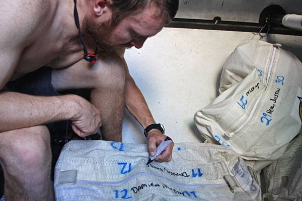 phil-harmer-and-ration-food-bags Phil Harmer With Ration Food Bags (Photo By Guo Chuan/Green Dragon/Volvo Ocean Race)