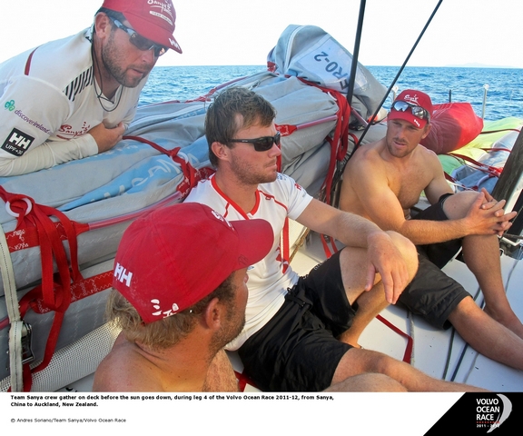 Team Sanya crew gather on deck before the sun goes down (Photo by Andres Soriano/Team Sanya/Volvo Ocean Race)